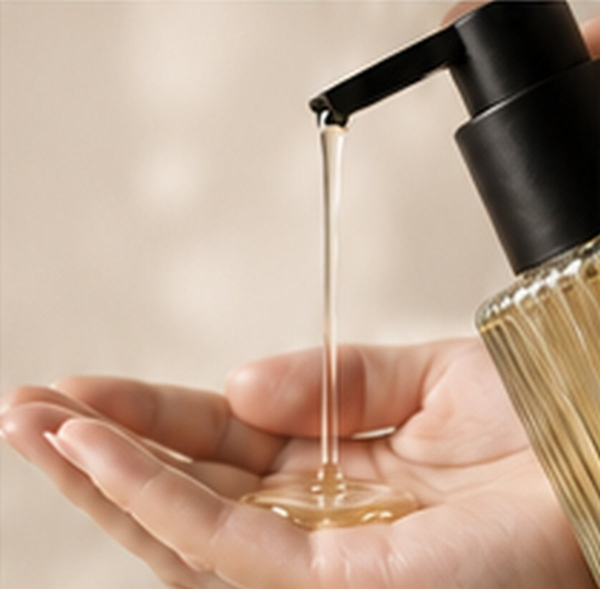 Shower oil dispensing into an open hand